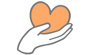 Hand carefully holding a green heart